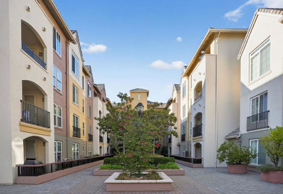 Courtyard view of a multi-story residential building with balconies.