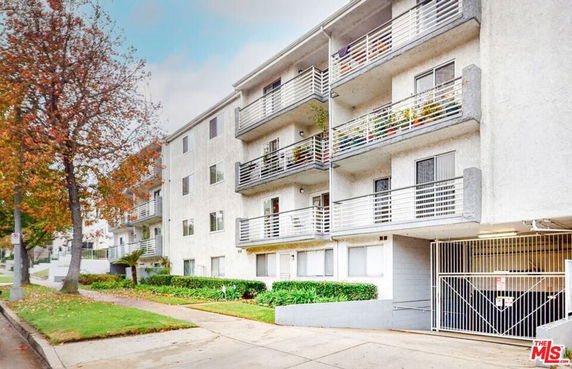 Front view of a multi-story residential building with balconies.