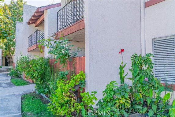 Exterior view of a building with balconies and landscaping.