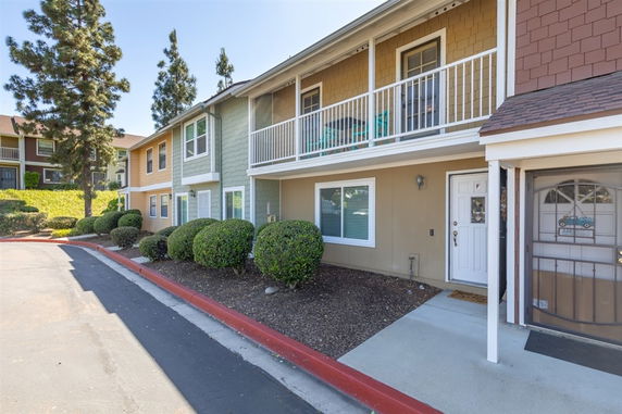 Front view of a two-story residential building with balconies.