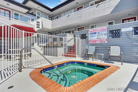 Outdoor area with a small fenced swimming pool.