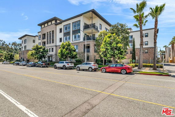 Front view of a multi-story residential building with balconies.