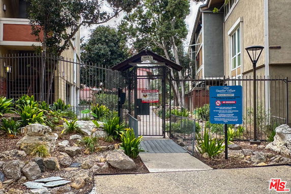 View of a gated entrance to a residential building complex.