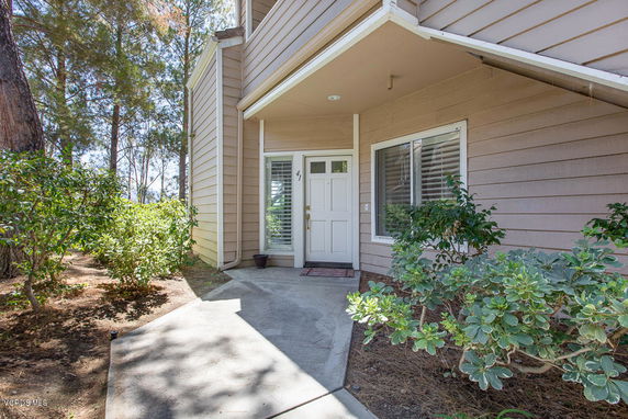 Front view of a house with an entrance and a small porch area.