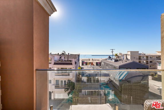 Panoramic view showing a coastal area with buildings and the sea in the distance.