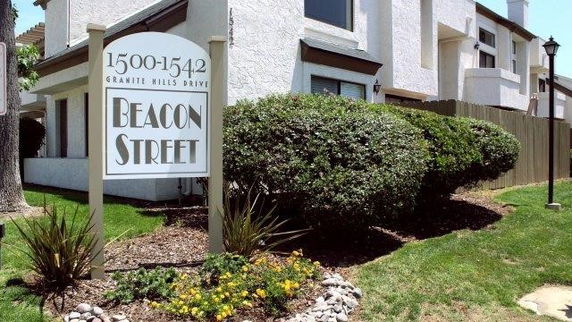 Front view of a two-story building with a sign reading 'Beacon Street.'