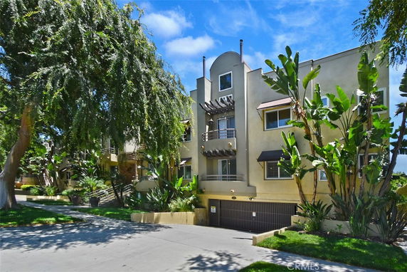 Front view of a multi-story residential building with modern architectural design.