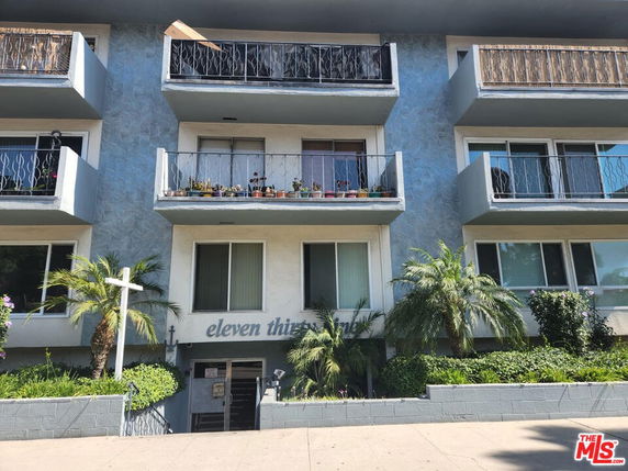 Front view of a multi-story residential building with balconies.