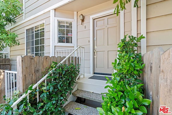 Front view of a house entrance with steps and a small porch.