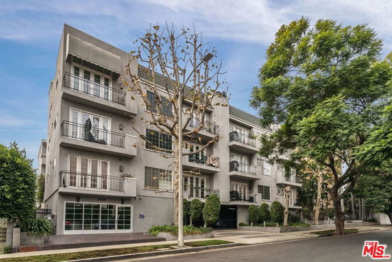 Front view of a multi-story residential building with balconies.