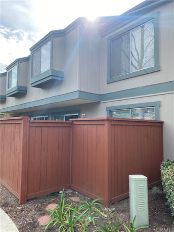 Front view of a two-story house with a fenced area.
