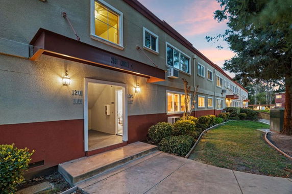 Front view of a two-story apartment building with entryway.