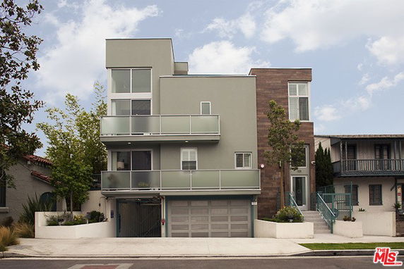 Front view of a modern multi-story house with a double garage.