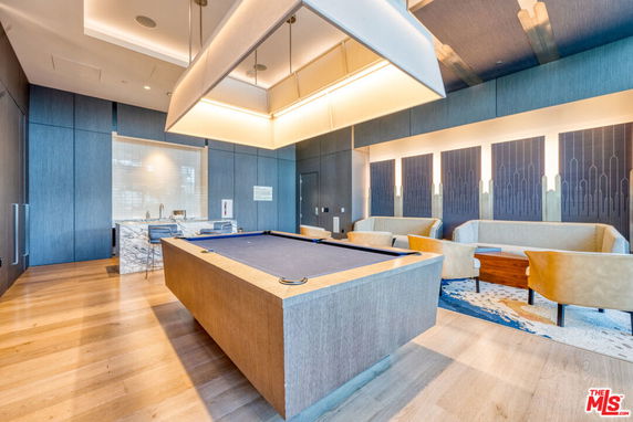 Interior view of a recreational room with a pool table and seating area.