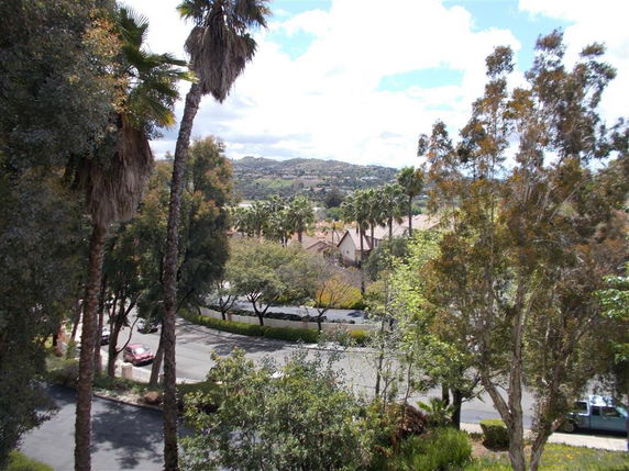 View of residential area surrounded by trees and hills