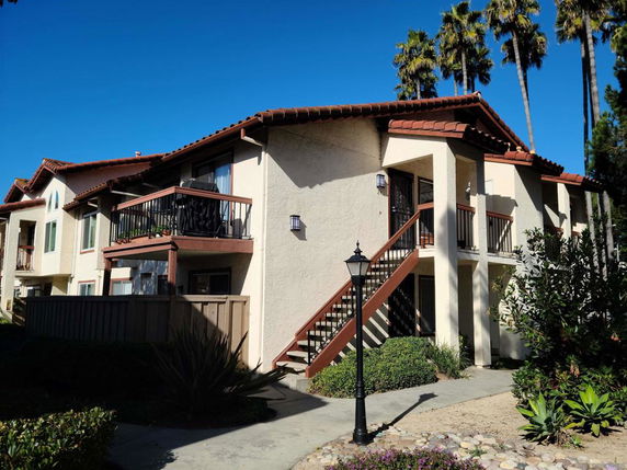 Front view of a two-story building with balconies.