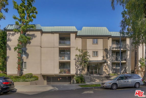 Front view of a multi-story residential building with balconies.