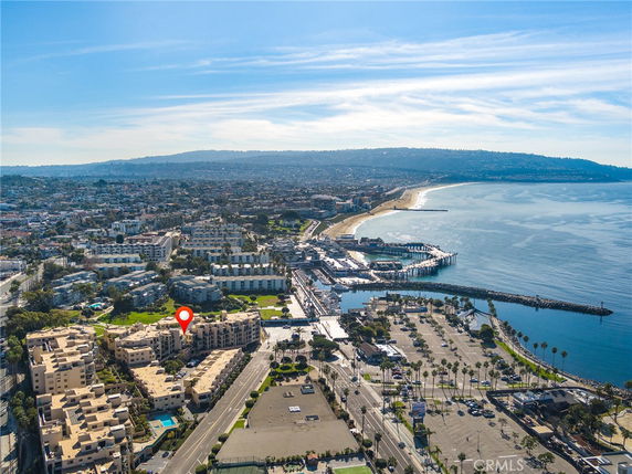 Panoramic view of a coastal area with buildings and a marina.