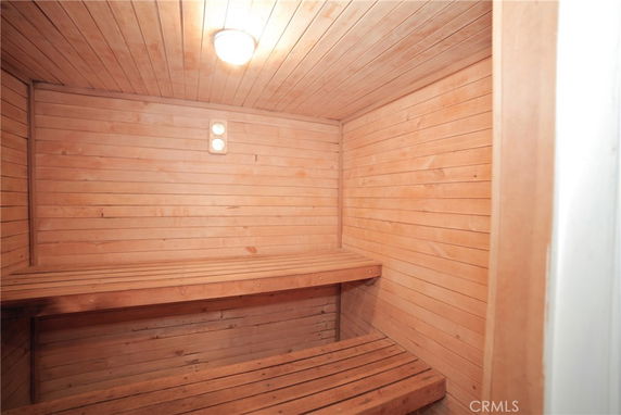 Interior view of a wooden sauna room with benches.