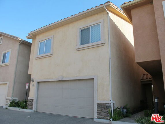 Front view of a two-story house with a double garage.