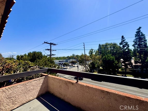 Panoramic view from a building showing nearby streets and trees.