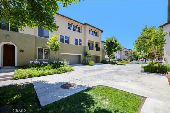 Front view of a multi-story residential building with garages.