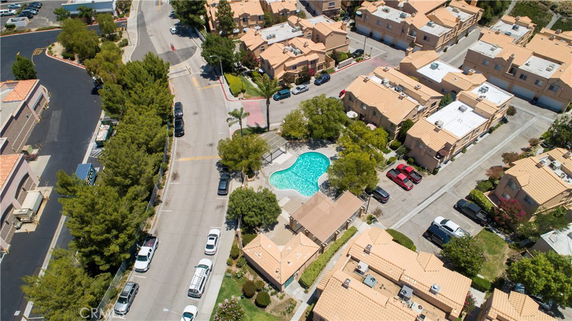 Aerial view of residential neighborhood with swimming pool in the center.