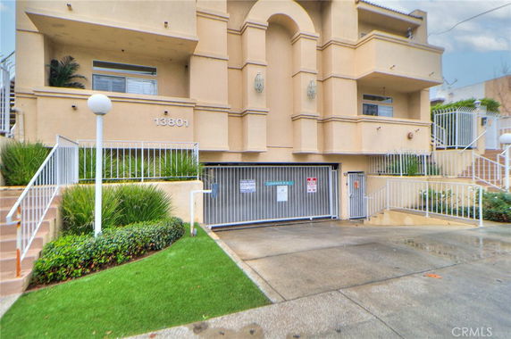 Front view of a multi-story building with a gated entrance.