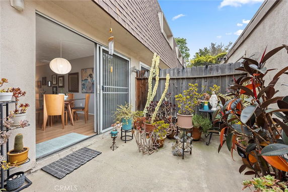 Outdoor area with sliding door leading to indoor dining space.