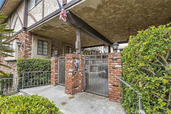 Front view of a multi-story house with brick and stucco exterior.