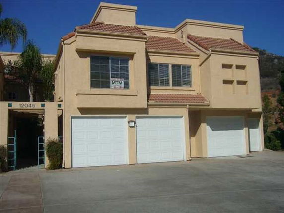 Front view of a two-story house with multiple garages.
