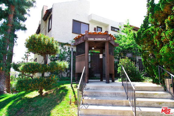 Front view of a multi-story building with a gated entrance.