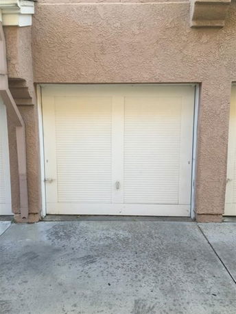 Front view of a building with a closed garage door.