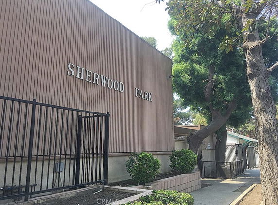Front view of a building with the name 'Sherwood Park' and a gated entrance.