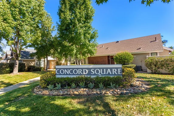 Front view of a house with a gable roof and a sign reading 'Concord Square.'