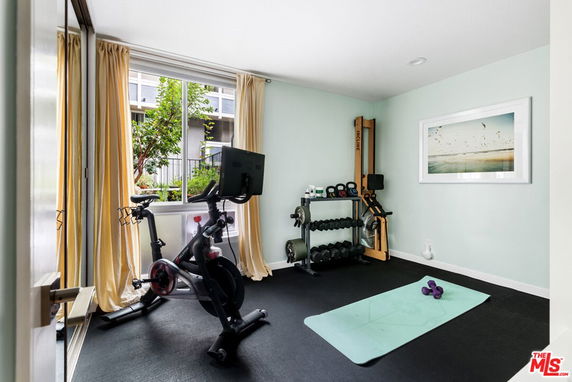 Indoor space with exercise equipment and large window.