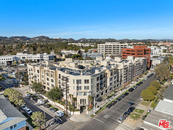 Elevated view of a multi-story apartment building in an urban area.