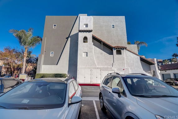 Front view of a multi-story building with a flat roof and modern design.