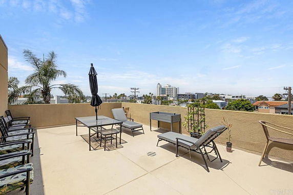 Outdoor rooftop area with seating and city view.