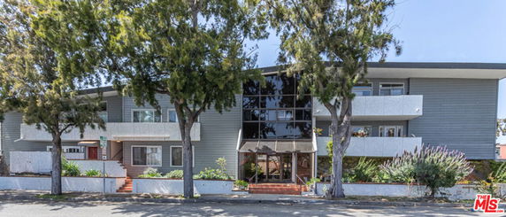 Front view of a two-story modern building with large windows and a central entrance.