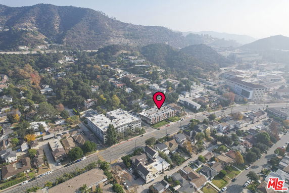 Aerial view of a residential area with hills in the background.