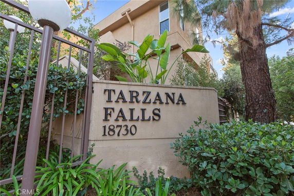 Front view of a building with 'TARZANA FALLS 18730' signage.