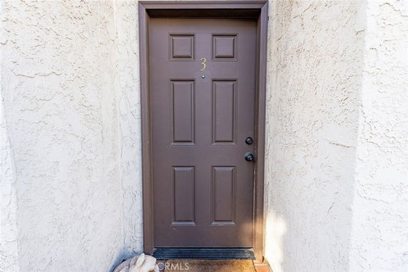Close-up view of a front door with the number 3 on it.