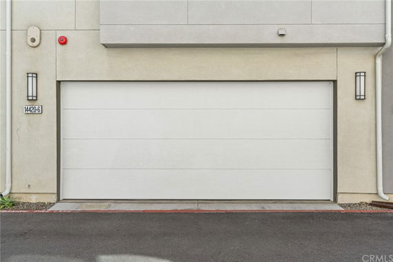 Front view of a house with a white garage door.