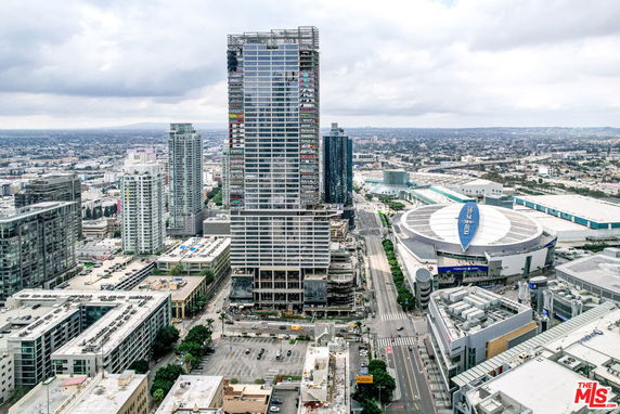 Skyline view with tall buildings and a prominent rounded structure.