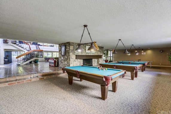 Indoor recreation area with multiple billiards tables.