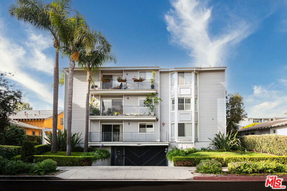 Front view of a multi-story residential building with balconies.