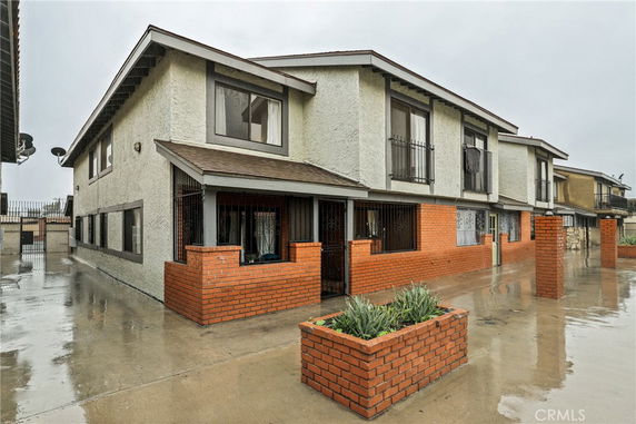 Front view of a two-story building with brick and stucco exterior.