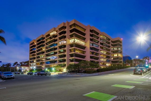 Front view of a multi-story building with unique angular balconies.