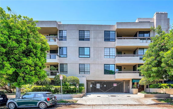 Front view of a multi-story apartment building with balconies.